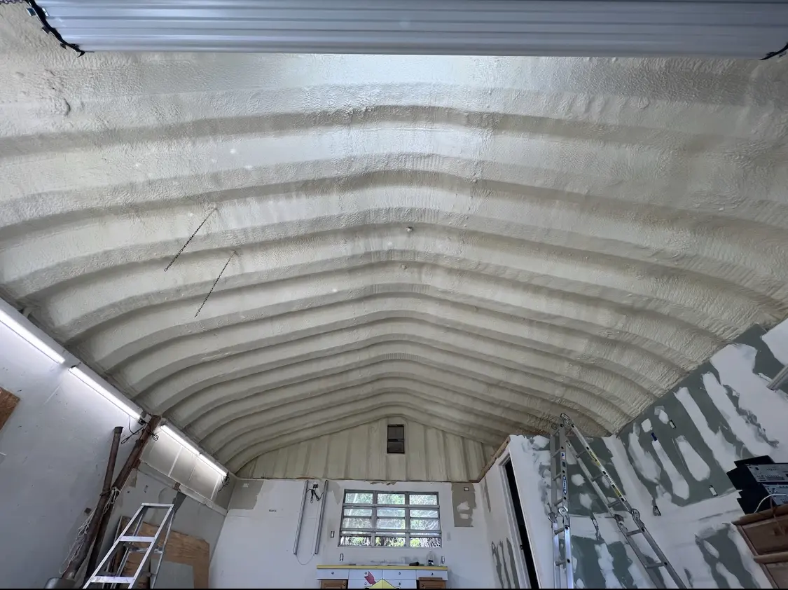 Spray polyurethane foam applied to the underside of a metal roof deck in Ozark